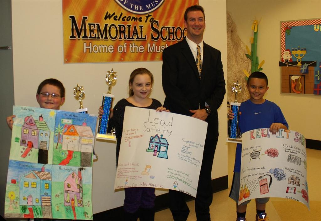 Monmouth County Health Officer Christopher Merkel congratulates the Union Beach Memorial School fourth grade students for winning the Health Department’s poster contest at an awards ceremony on Nov. 25. Pictured left to right: First place winner Joshua Jacob, third place winner Julia Anderson, Christopher Merkel and second place winner C.J. Murgolo. 